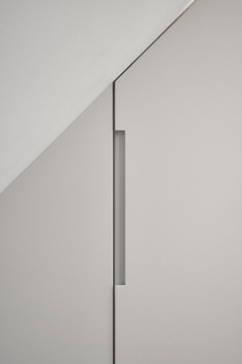Detail view of attic conversion Vienna: custom cabinet fronts with precise integrated handles