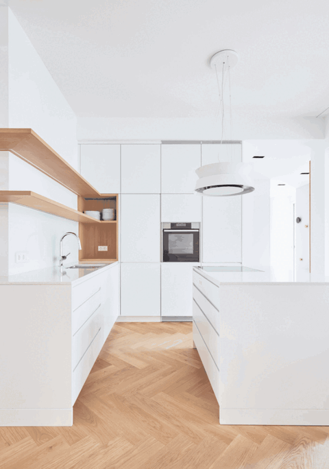 Modern bathroom with large mirror, white cabinetry and wooden shelves