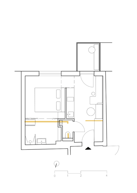 Grundriss der kleinen Wohnung mit Schlafbereich und angrenzendem Badezimmer.