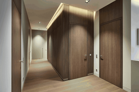 Blick in den Korridor mit Holzboden, verdeckter Beleuchtung und schlichten Holzoberflächen.